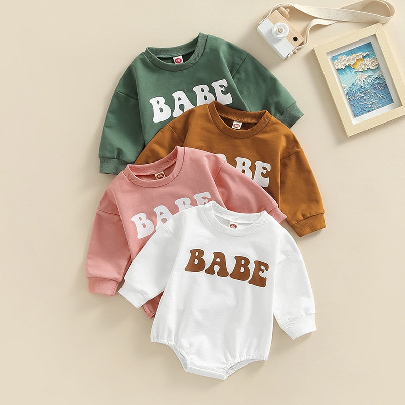Adorable green long sleeve BABE bubble romper for baby boys and girls by August + Willow, suitable for 0-3 months.