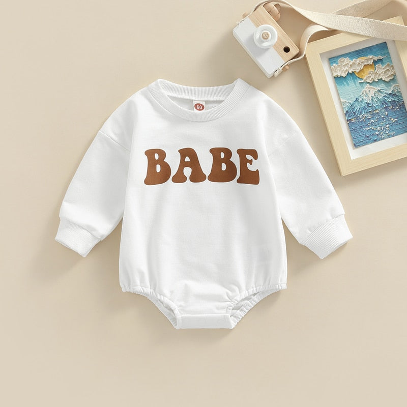 Adorable green long-sleeve baby romper by August + Willow for boys and girls, featuring a cute bubble design for infants 0-3 months.
