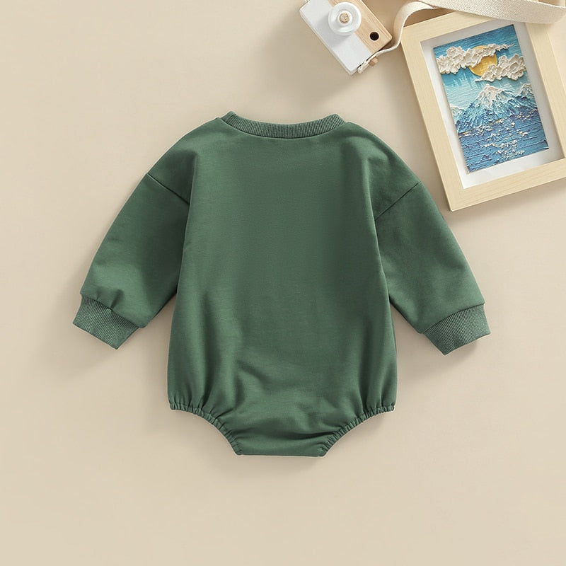 Adorable green long sleeve BABE bubble romper for baby boys and girls from August + Willow, suitable for 0-3 months.