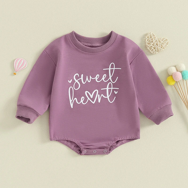 Baby girls and boys Valentine's Day long sleeve bubble romper by August + Willow with heart letter design for infants aged 0-3 months.