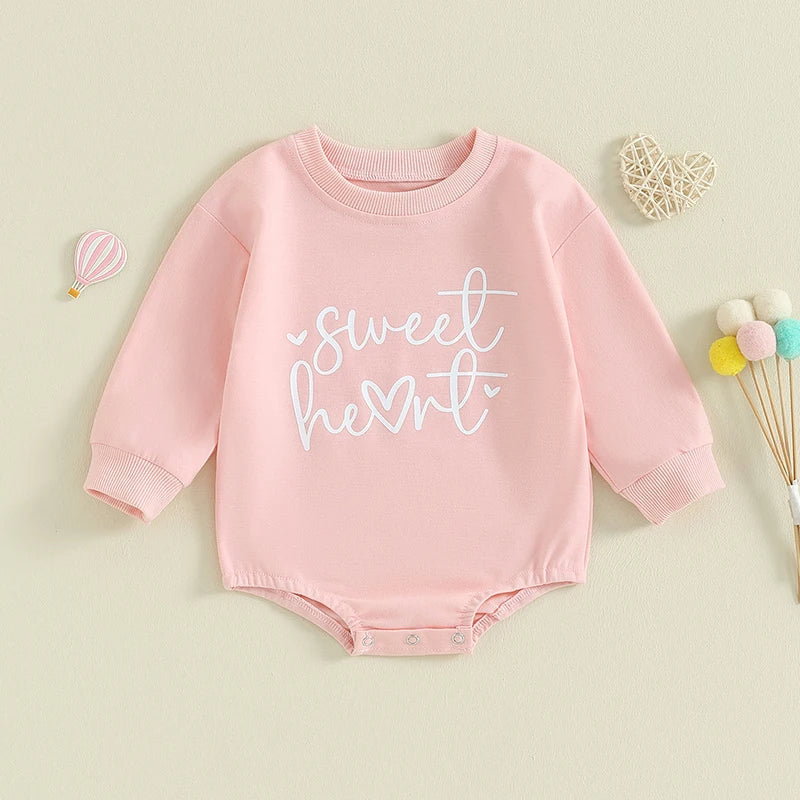 Baby girl and boy Valentine’s Day long sleeve bubble romper by August + Willow, featuring sweet heart letters for infants aged 0-3 months.