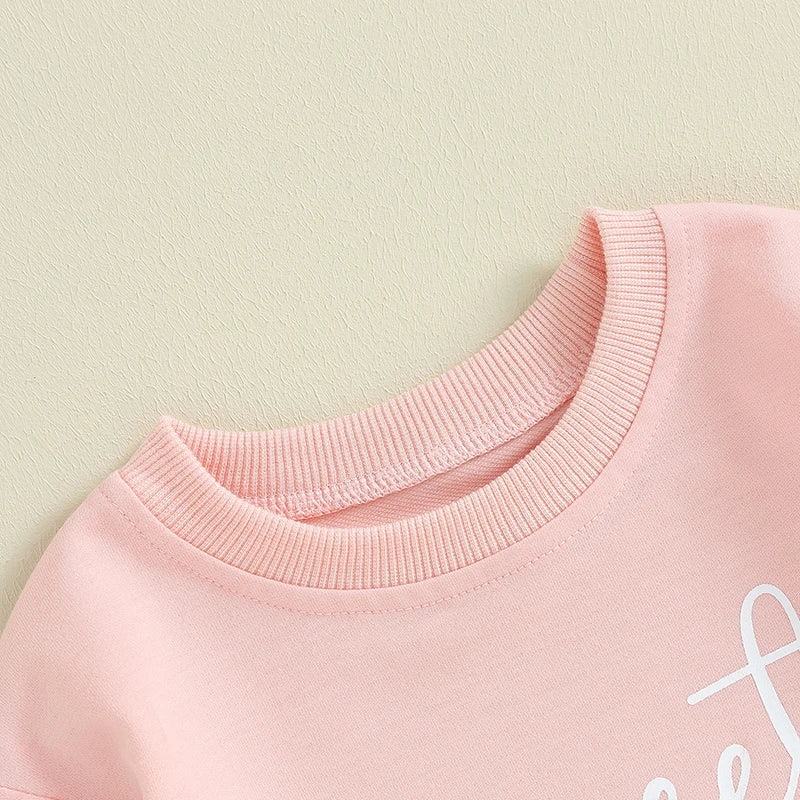 Baby girls and boys Valentine’s Day long sleeve bubble romper by August + Willow, featuring sweet heart and letter prints.