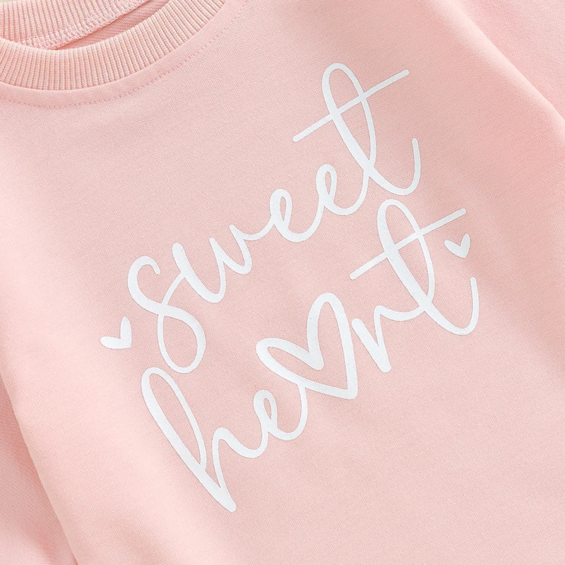 Baby girls and boys Valentine’s Day long sleeve bubble romper by August + Willow with sweet heart letter print, suitable for 0-3 months.