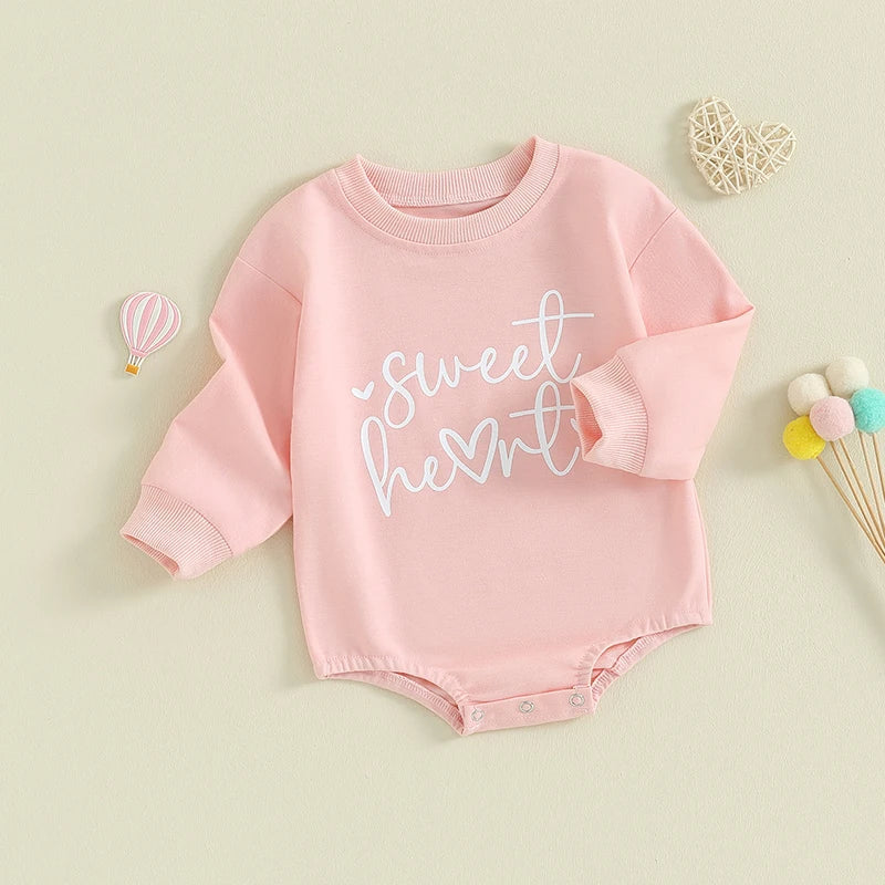 Baby girls and boys Valentine's Day long-sleeve bubble romper by August + Willow with heart letter design for infants 0-3 months.