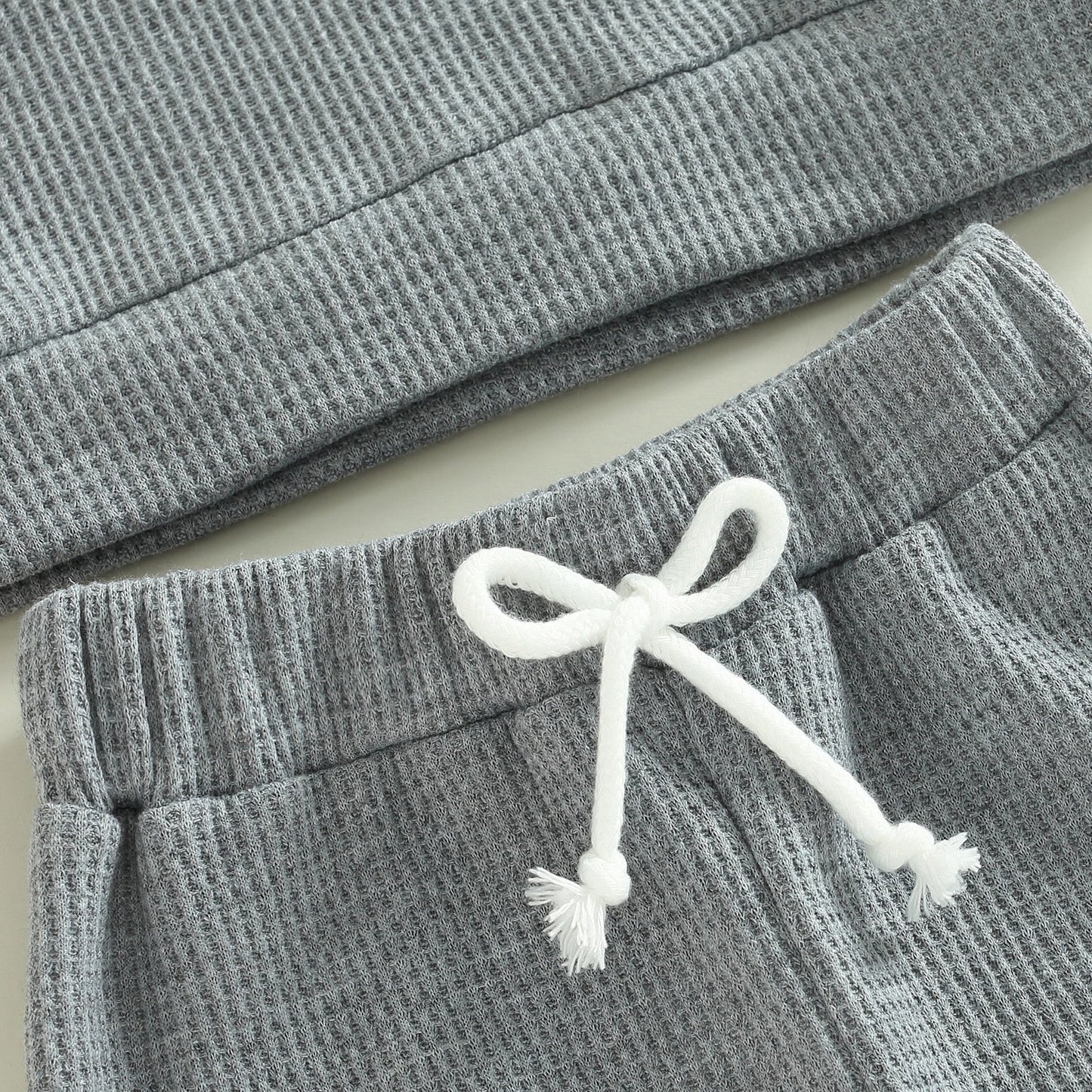 Grey 2-piece baby toddler outfit with long sleeve ribbed knit tops and pants from August + Willow for girls and boys.