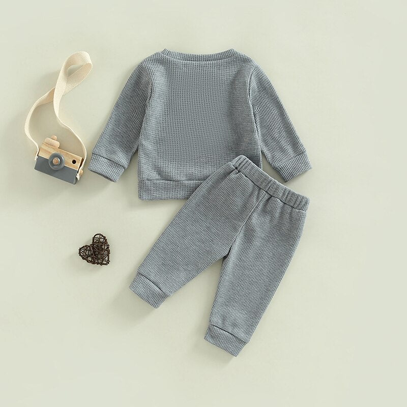 Grey 2-piece toddler outfit by August + Willow with long sleeve ribbed knit tops and pants for baby girl and boy, 18-24 months.