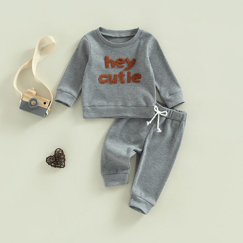 Grey 2-piece baby and toddler outfit by August + Willow with long sleeve ribbed knit tops and matching pants for boys and girls.