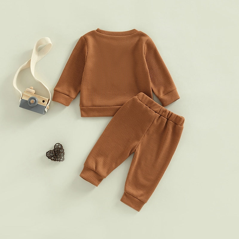 Gray toddler girl and boy 2-piece ribbed knit outfit with long sleeve tops and pants by August + Willow for ages 18-24 months.