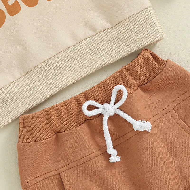 Baby boys and girls 2-piece outfit by August + Willow, khaki long sleeve pullover and jogger pants with letter Auntie's Little Bestie print.