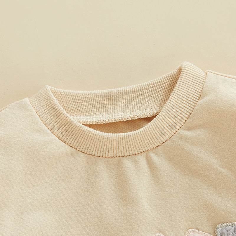 Infant baby girl fall bodysuit by August + Willow, fuzzy letter love print, long sleeve, round neck, cozy bubble romper in cream.