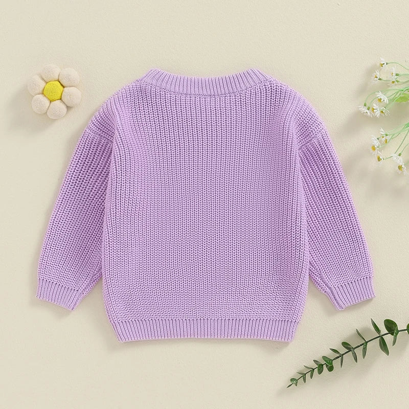 Light pink toddler girl sweater by August + Willow with cute long sleeves, letter embroidery, and a cozy knit loose fit.