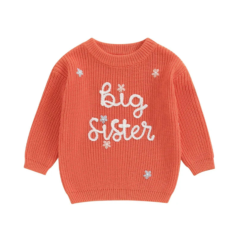 Light pink toddler girl sweater by August + Willow with long sleeves and embroidered letter "Big Sister" design, soft knit pullover.