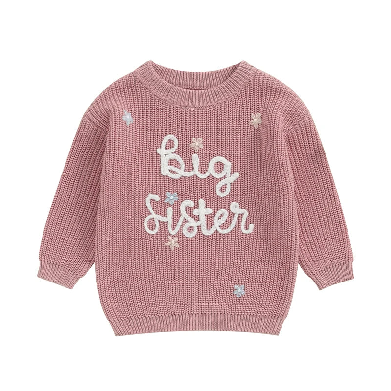 Light pink toddler girl sweater from August + Willow with long sleeves and embroidered letter design, cozy knit pullover for little girls.