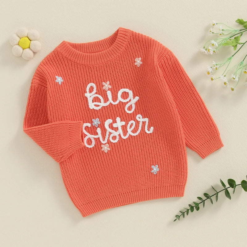 Light pink toddler girl sweater by August + Willow with long sleeves, letter embroidery, and a loose knit pullover design.