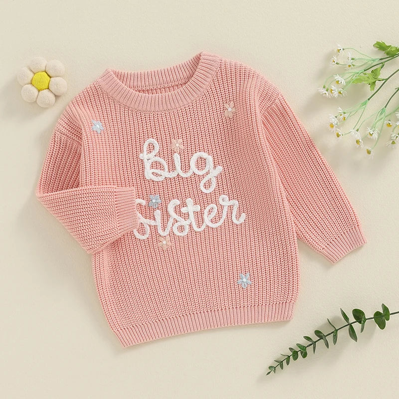 Light pink toddler girl sweater with long sleeves and letter embroidery, loose fit knit pullover from August + Willow.