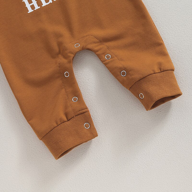 Baby boy or girl romper by August + Willow featuring a western bull head and letter print, long sleeves, perfect for fall.