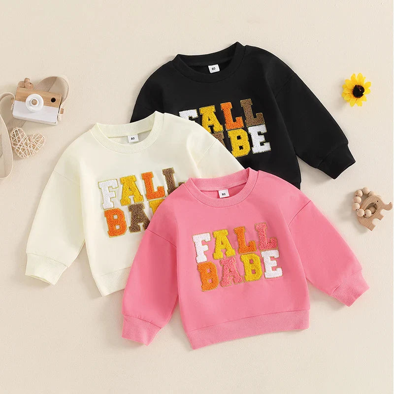 Pink baby and toddler fall crewneck top by August + Willow, long sleeve with embroidered letters for boys and girls.