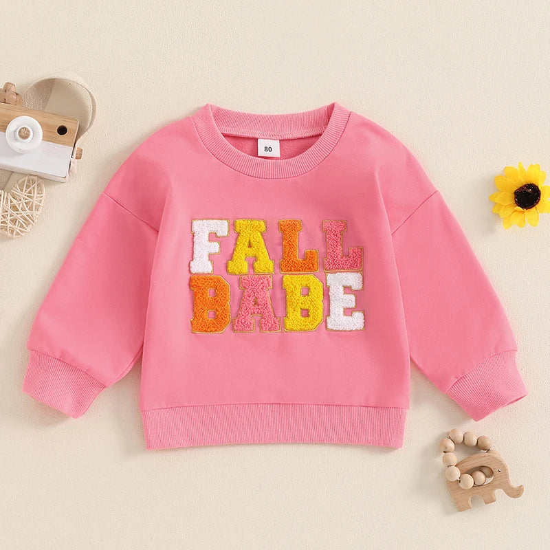 Pink baby and toddler long sleeve fall crewneck top with embroidered letters by August + Willow, suitable for boys and girls ages 6-12 months.