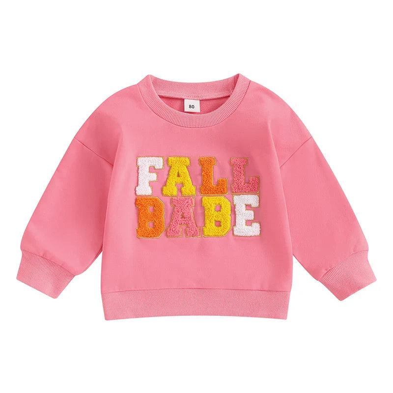 Pink baby and toddler fall crewneck top by August + Willow with embroidered letters, long sleeves, suitable for boys and girls ages 6-12 months.