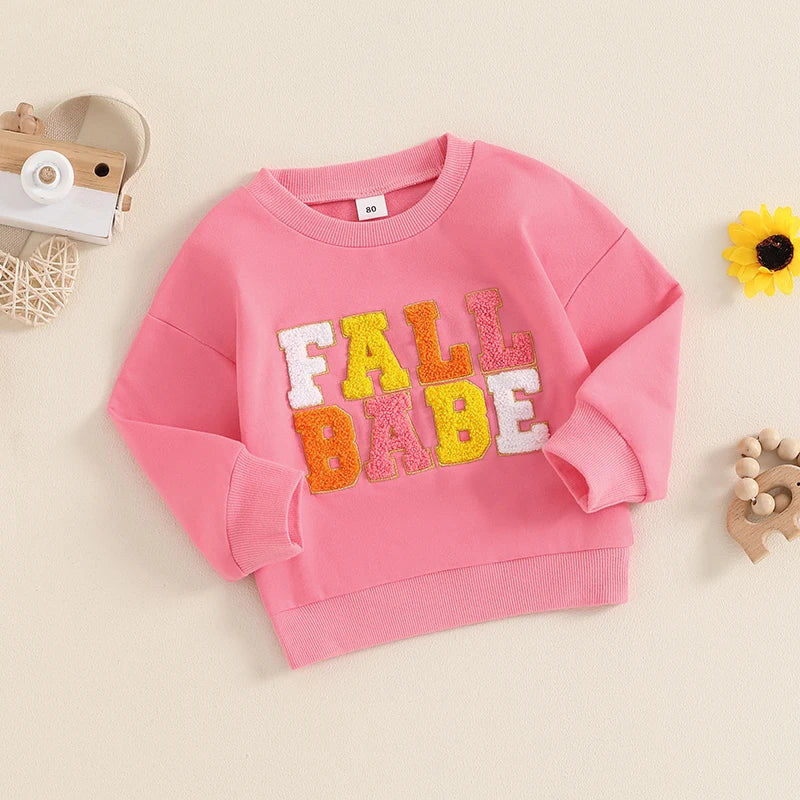 Pink fall crewneck top for baby and toddler boys and girls by August + Willow, with embroidered letters and long sleeves.