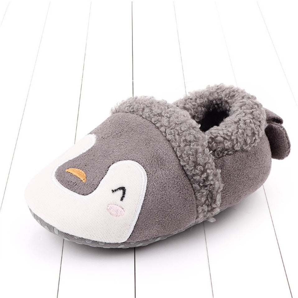 Pink animal slippers for newborns by August + Willow, featuring anti-slip soles and cute penguin design for first steps.