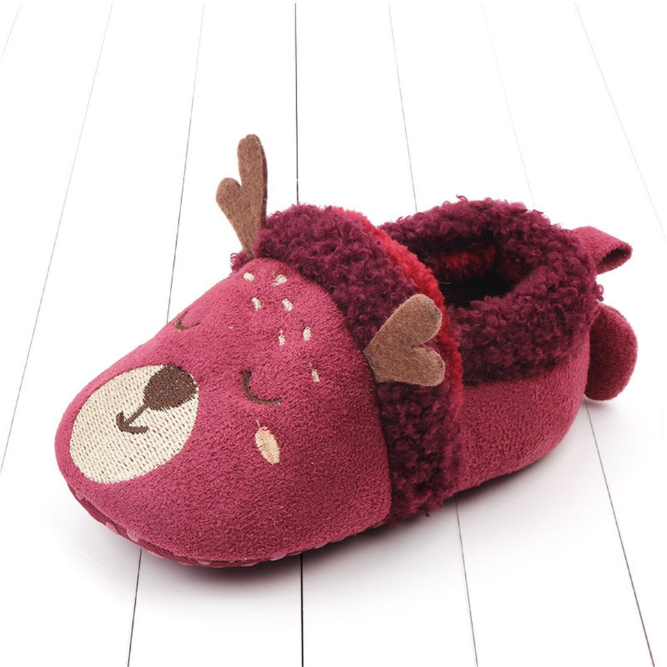 Pink penguin baby slippers with anti-slip soles, designed for newborns and first walkers, by August + Willow.
