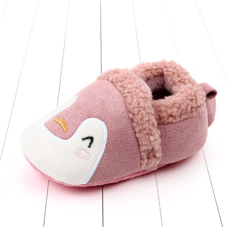 Pink animal slippers for newborns and infants, anti-slip first walker shoes by August + Willow with cute penguin design.