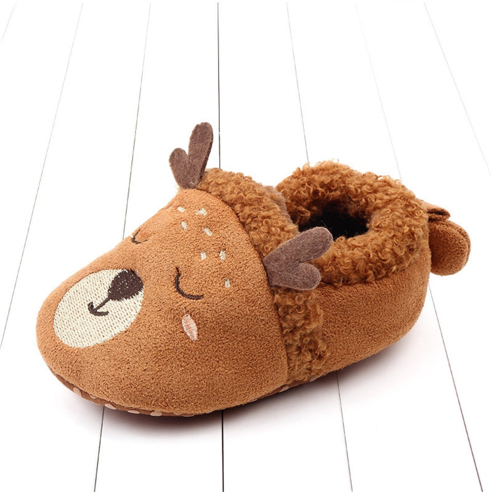 Pink animal slippers for newborns and infants, anti-slip first walker shoes by August + Willow with cute penguin design.