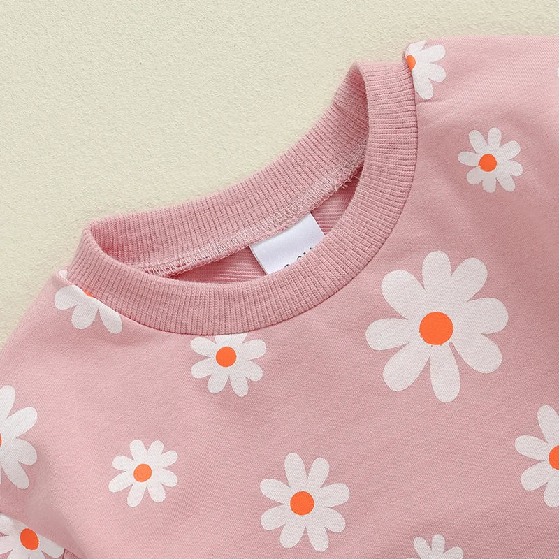 Baby girl bubble romper by August + Willow with daisy flower print, long sleeves, round neck, perfect for toddlers age 6-12 months.