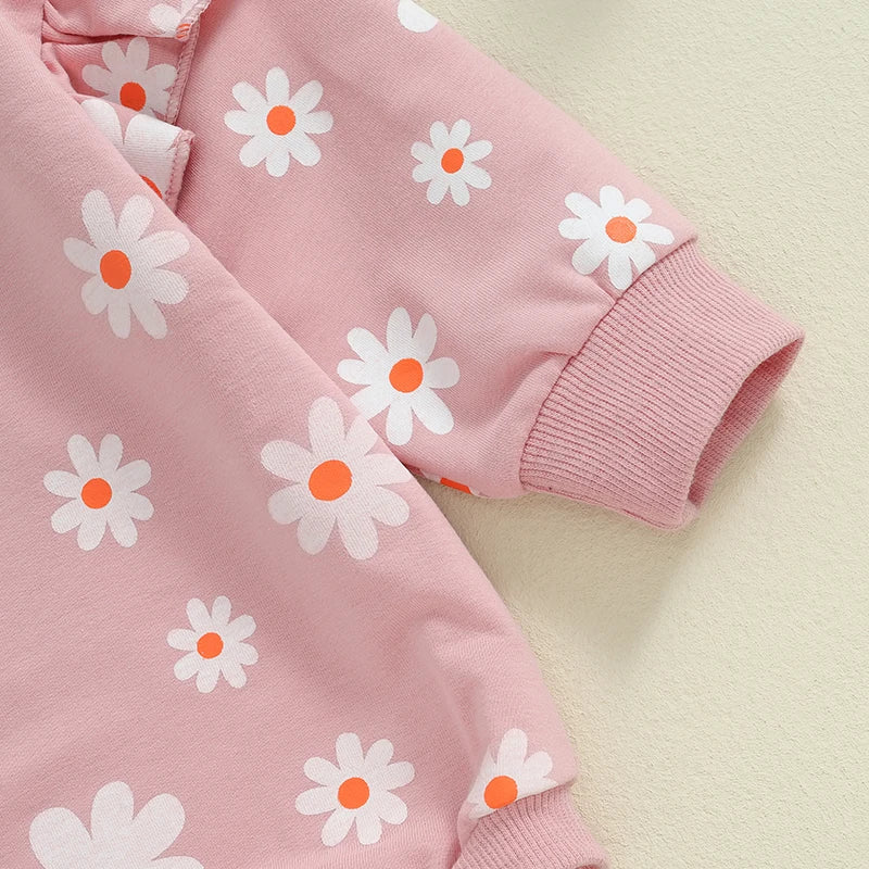 Baby girl in purple bubble romper with daisy flower print, long sleeves, round neck, and comfortable fit from August + Willow.