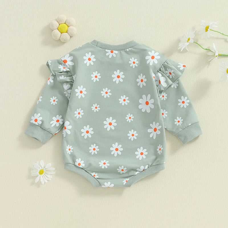 Baby girl in a purple flower daisy print bubble romper with long sleeves and round neck, by August + Willow.