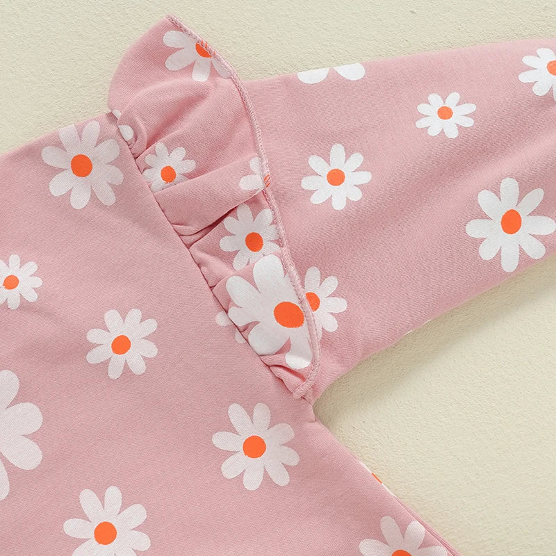 Baby girl bubble romper by August + Willow with daisy flower print, long sleeves, round neck, and comfortable fit for 6-12 months.