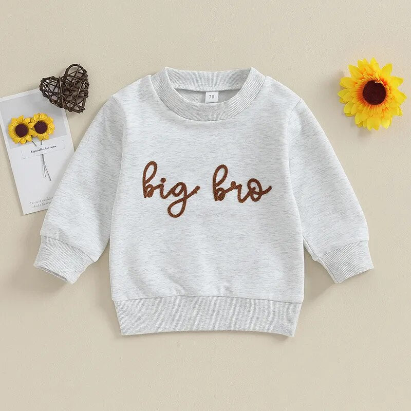 Toddler baby boy in a long sleeve crewneck top with "Big Lil Bro" letters, matching brother romper, by August + Willow.
