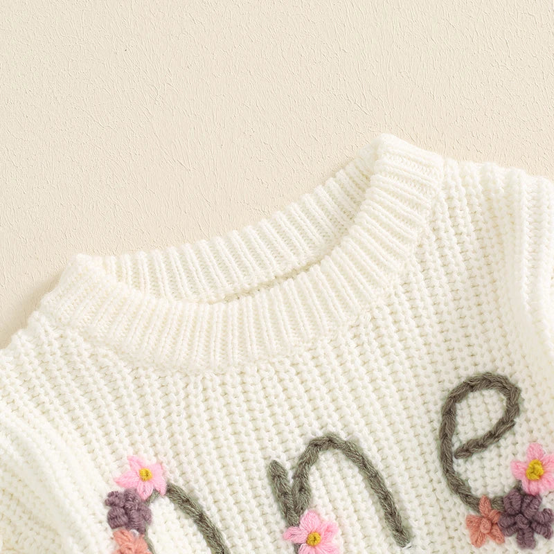 Baby girl birthday sweater by August + Willow featuring floral embroidery, letter details, long sleeves, and cozy knit fabric for infants.