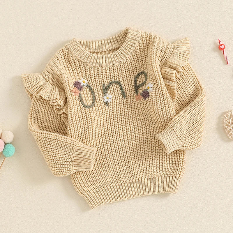 Baby girl birthday sweater by August + Willow with floral embroidery, letter details, long sleeves, and cozy knitwear for infants.