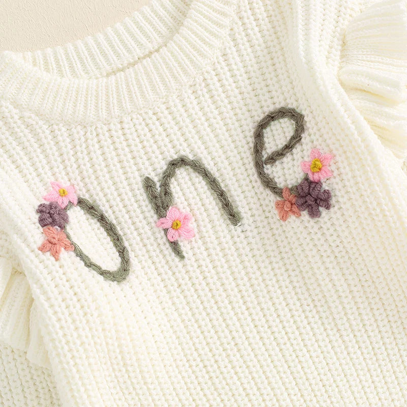 Baby girl birthday sweater by August + Willow, white long sleeve knitted top with floral embroidery, letter details, cozy toddler outfit.