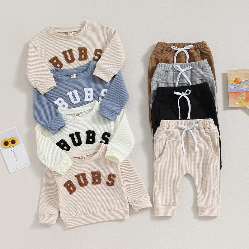 Baby and toddler boys and girls 2-piece long sleeve letter embroidery bubs tops with drawstring pants set by August + Willow.