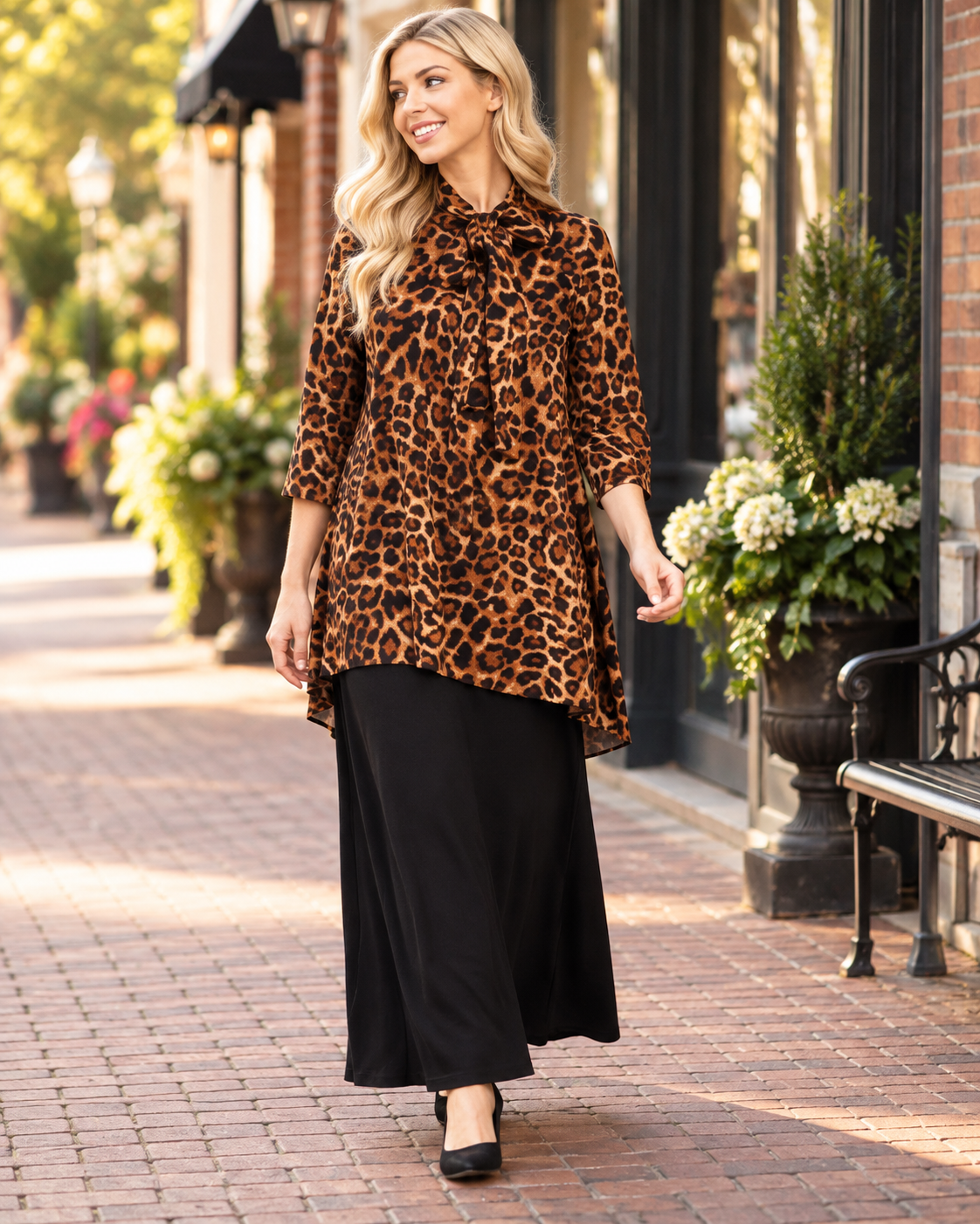 Leopard print bow-tie A-line modest top with 3/4 sleeves by Celeste Clothing, shown being worn while walking.
