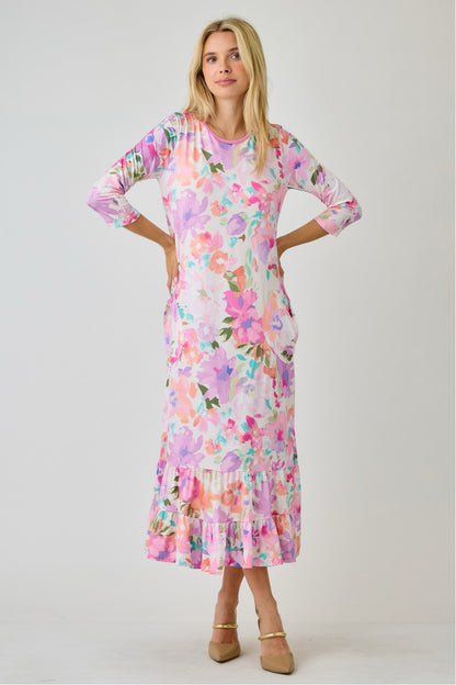 Navy watercolor summer floral tiered ruffle dress with pockets from Celeste Clothing, displayed on a hanger.