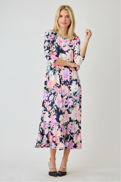 Navy watercolor floral tiered ruffle dress with pockets by Celeste Clothing, perfect for summer, shown on a hanger.