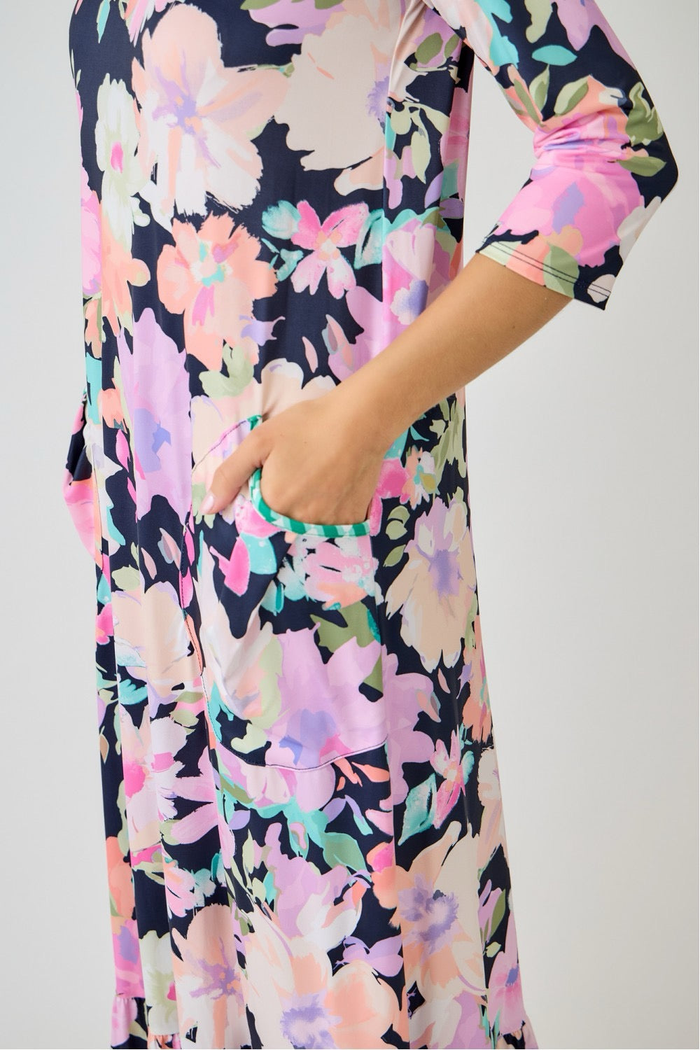 Navy watercolor floral tiered ruffle dress with pockets by Celeste Clothing, perfect for summer, displayed on a hanger.