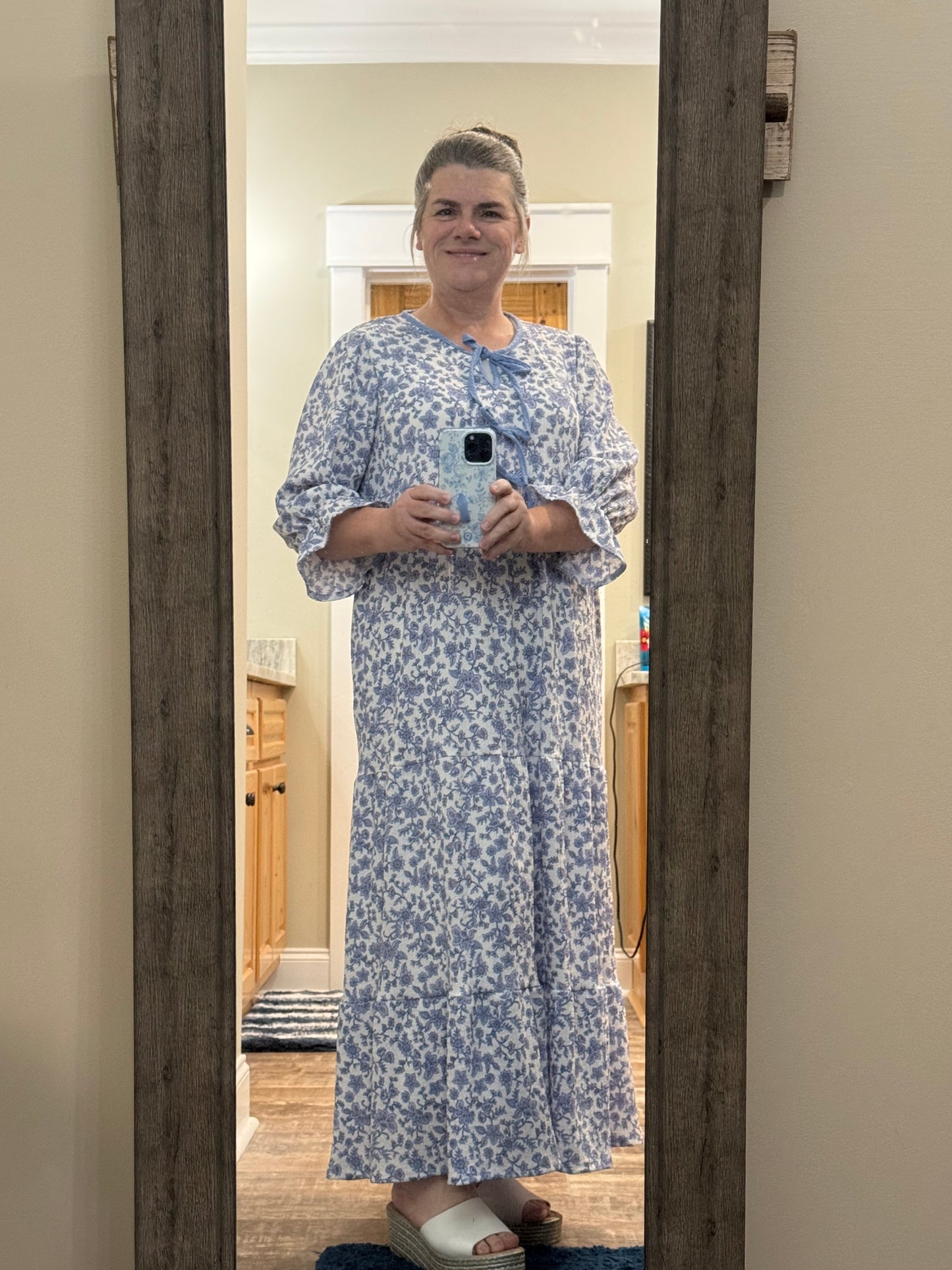 French Blue Floral Maxi Dress by Celeste Clothing featuring gauze-like fabric and a bow accent, styled for a summery look.