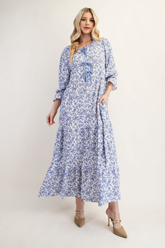 French blue floral maxi dress by Celeste Clothing featuring gauze-like fabric and a bow accent, perfect for elegant summer wear.