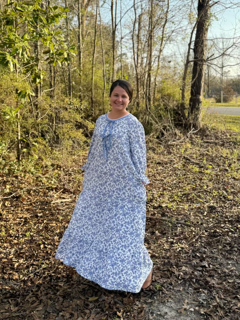 French Blue Floral Maxi Dress by Celeste Clothing featuring gauze-like fabric and bow accent, shown on a model.