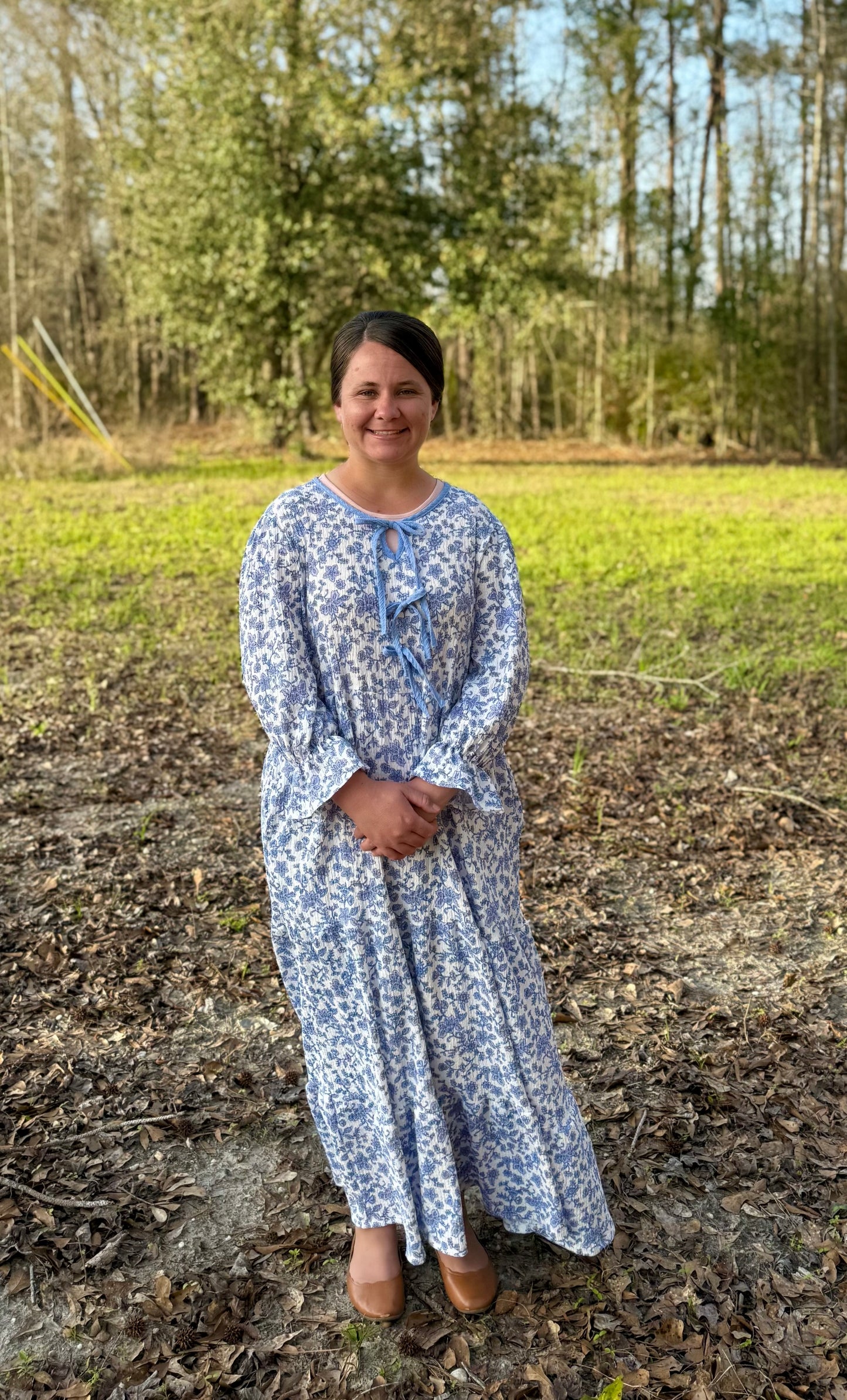 French Blue Floral Maxi Dress by Celeste Clothing featuring gauze-like fabric and a decorative bow accent.