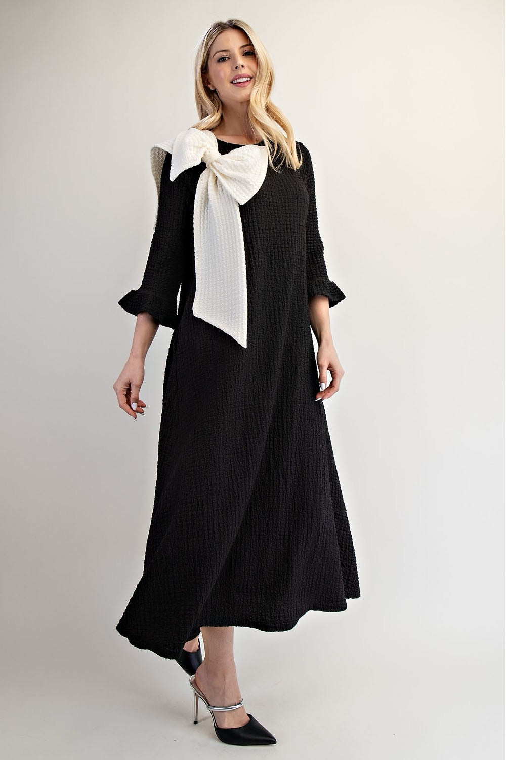Celeste Glam Big Bow Dress showing a stylish dress with a large bow detail, perfect for elegant occasions.