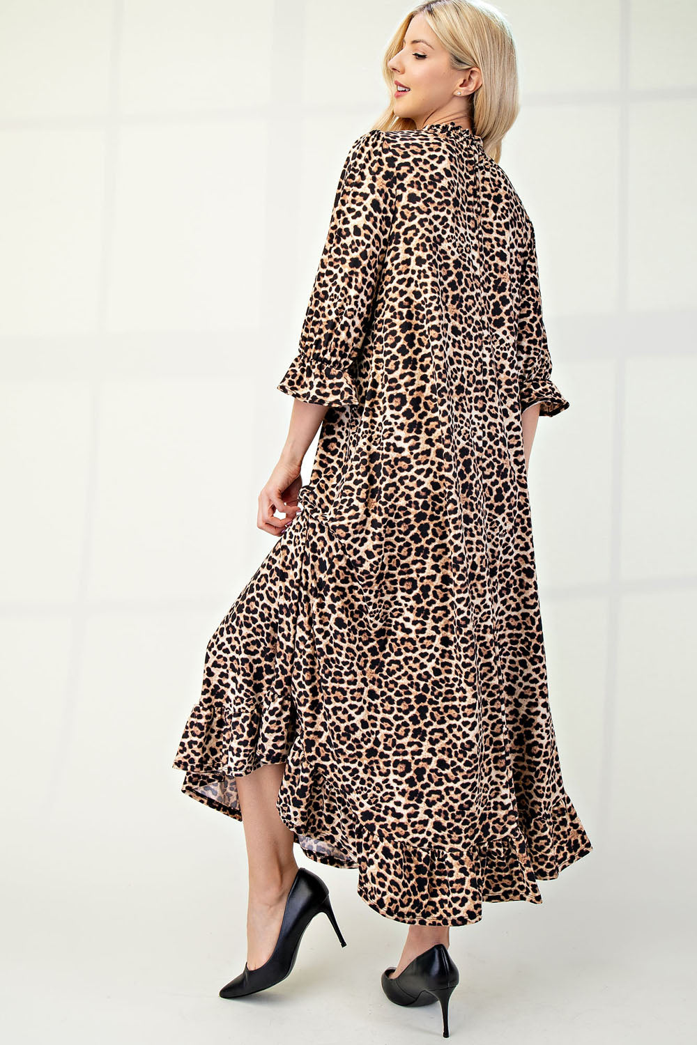Plus size leopard print dress with 3/4 sleeves and ruffle trim by Celeste Clothing, featuring a stylish and comfortable design.