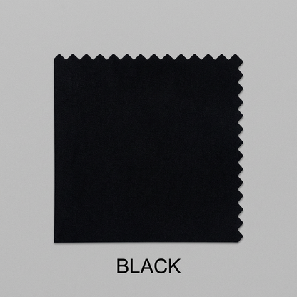 A black fabric color swatch with zigzag-cut edges, shown on a light gray background with the word BLACK below it.