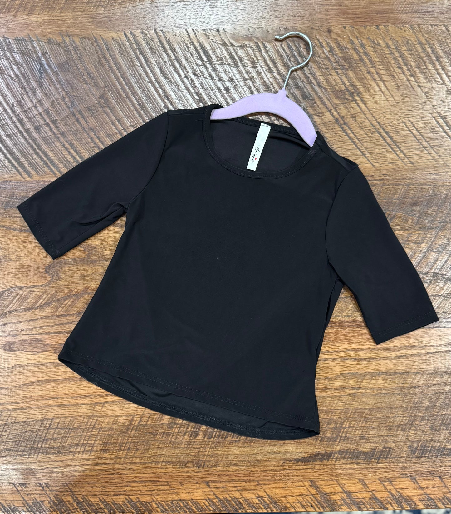 Girl's black 3/4 sleeve layering top by Celeste Clothing, soft fabric with a comfortable fit, perfect for layering in casual outfits.
