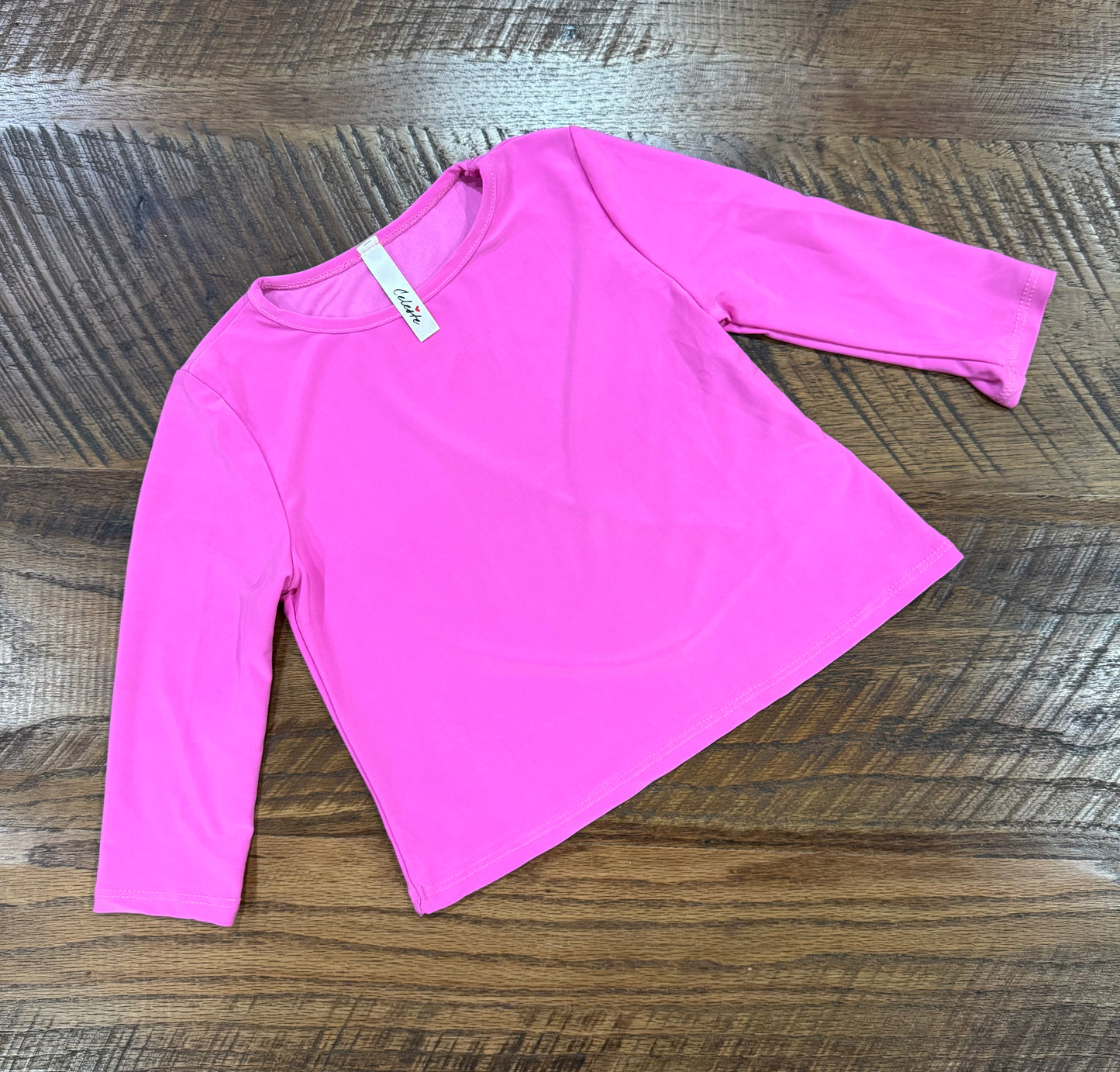 Girl wearing black long sleeve Lux layering top by Celeste Clothing, stylish and comfortable for layered outfits.